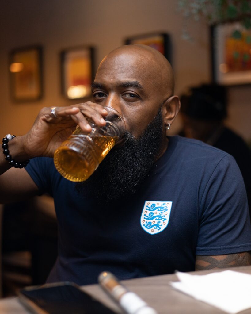 A middle-aged man enjoying a glass of star beer at demi's restaurant